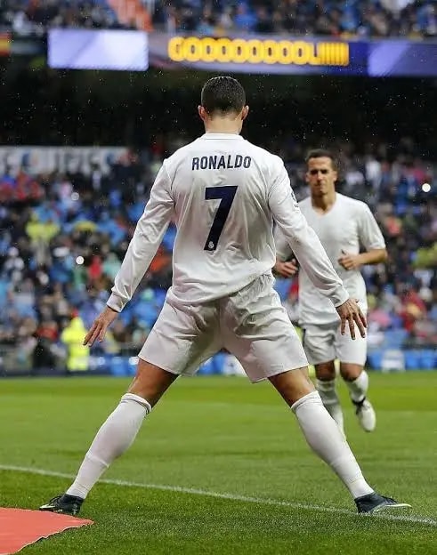 A player celebrating a goal in front of the crowd